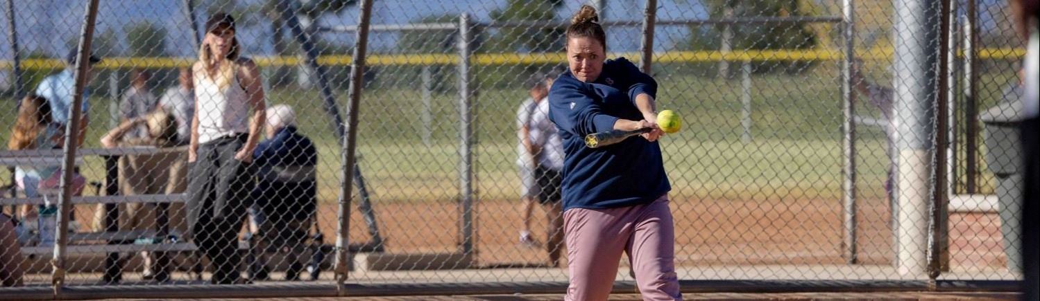 A softball player batting
