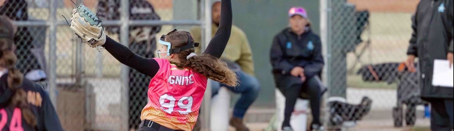 A girl pitching a softball