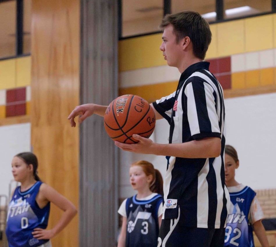 A basketball referee holding a basketball