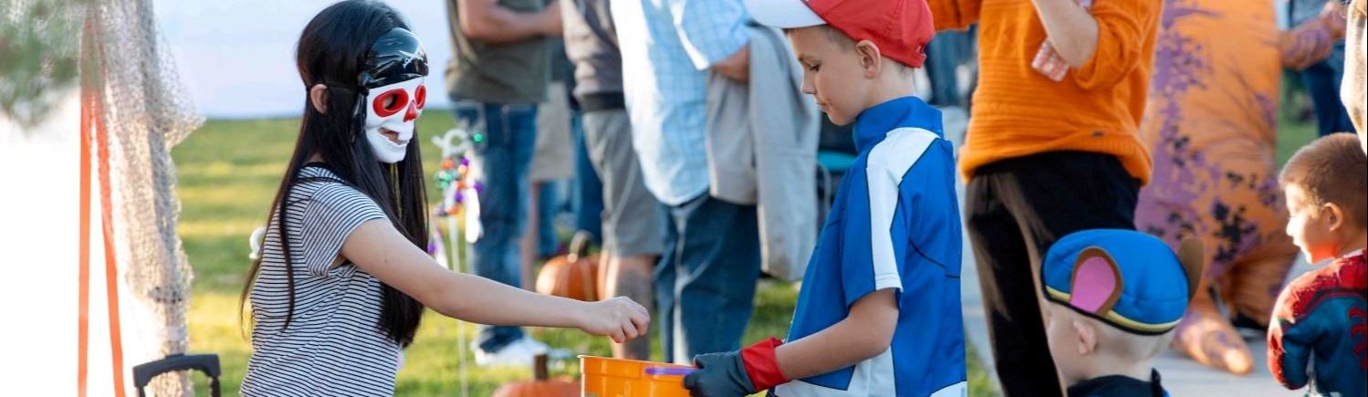 Kids dressed up in a costume trick-or-treating
